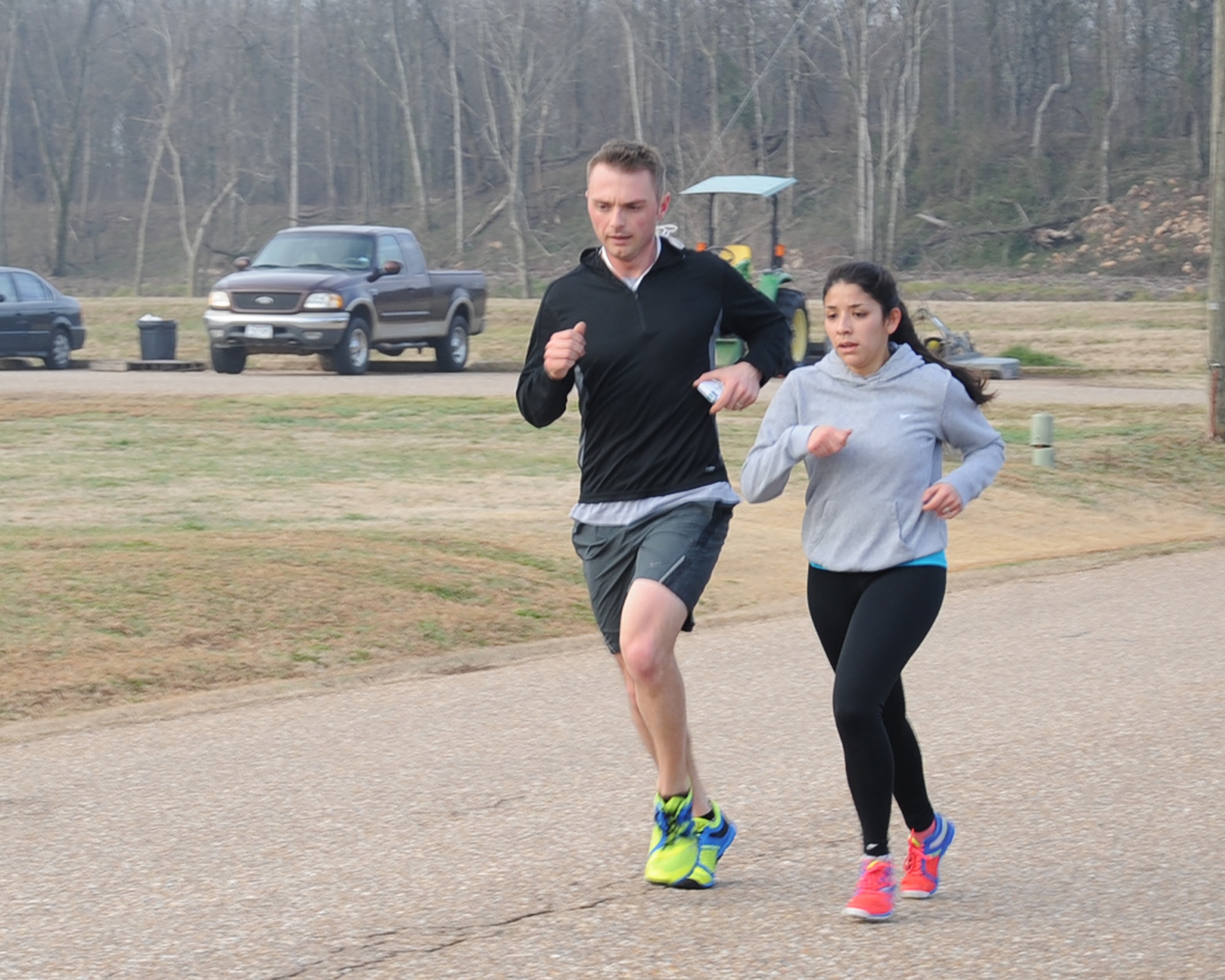 Capt Ryan Walton, Air Force Global Strike Command chief of modeling and simulation, and his wife 1st Lt. Melanie Walton, 608th Air Operations Center intelligence, surveillance and reconnaissance operations chief, cross the finish line during the Love 5K run on Barksdale Air Force Base, La., Feb. 14, 2014. The couple finished with a time of 22:14. (U.S. Air Force photo/Staff Sgt. Sean Martin)

