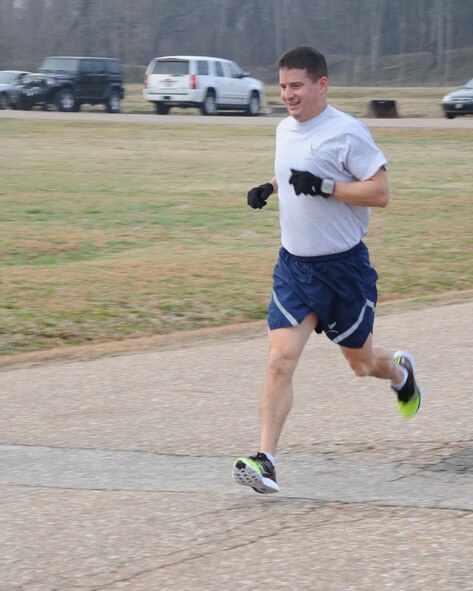 Lt. Col. Charles McElvaine, 2nd Operations Support Squadron, crosses the finish line during the Love 5K run on Barksdale Air Force Base, La., Feb. 14, 2014. McElvaine finished with a time of 17:53. (U.S. Air Force photo/Staff Sgt. Sean Martin)