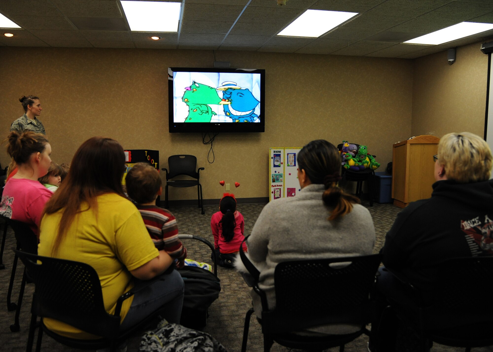 Daycare providers and their children watch a movie at the 2nd Dental Squadron on Barksdale Air Force Base, La., Feb. 14, 2014. The video, along with other presentations, were provided by the dental squadron to promote National Children's Dental Health Month. (U.S. Air Force photo/Senior Airman Joseph A. Pagán Jr.)