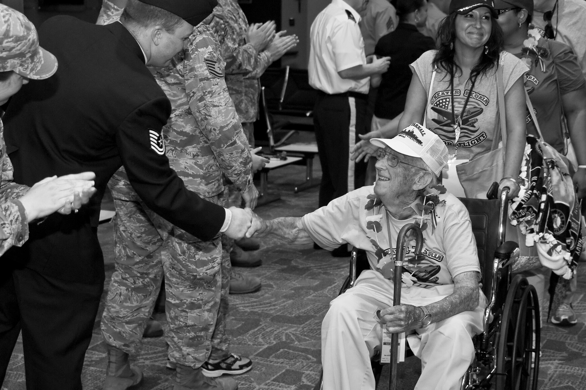 U.S. Air Force Tech. Sgt. Nicholas A. Connell of the 182nd Airlift Wing greets a U.S. Armed Forces veteran after his return home from the inaugural Greater Peoria Honor Flight at the General Wayne A. Downing Peoria International Airport in Peoria, Ill., June 4, 2013. The photo was one of five by Staff Sgt. Lealan C. Buehrer, photojournalist with the 182nd Airlift Wing, submitted to the National Guard Bureau media contest. Buehrer was announced the winner of the Air National Guard Outstanding New Photographer category on Feb. 3, 2014. (U.S. Air National Guard photo by Staff Sgt. Lealan Buehrer/Released)