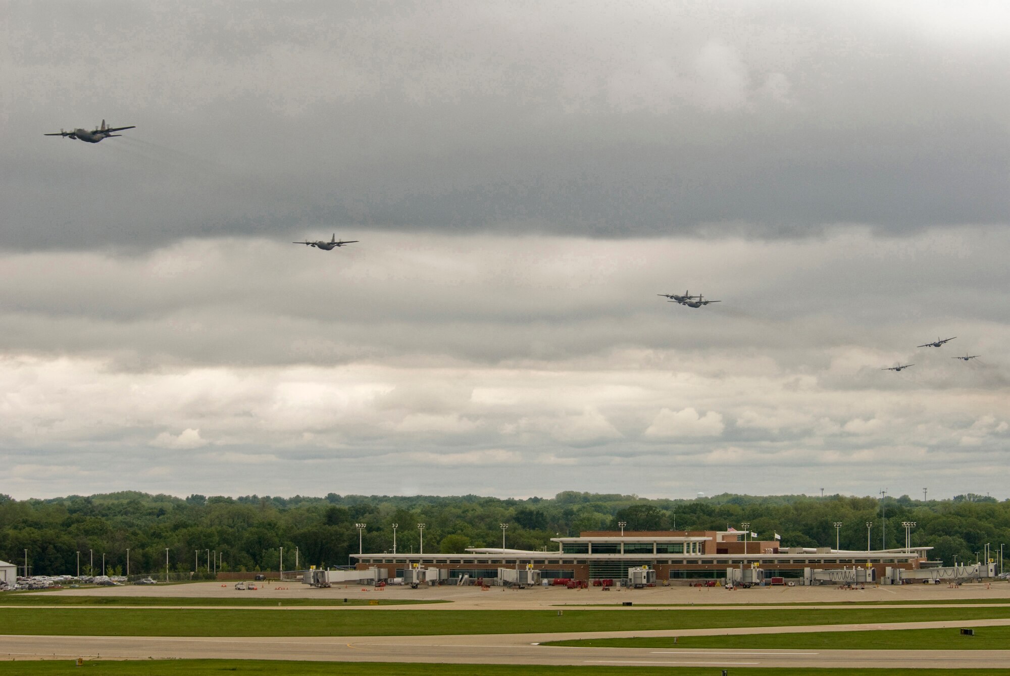 Illinois Air National Guard C-130H3 Hercules aircraft conduct a flyby over the 182nd Airlift Wing in Peoria, Ill., June 2, 2013. The military transport planes created a rare occurrence when seven of the Air National Guard Base’s aircraft flew together simultaneously in formation. The photo was one of five by Staff Sgt. Lealan C. Buehrer, photojournalist with the 182nd Airlift Wing, submitted to the National Guard Bureau media contest. Buehrer was announced the winner of the Air National Guard Outstanding New Photographer category on Feb. 3, 2014. (U.S. Air National Guard photo by Staff Sgt. Lealan Buehrer/Released)