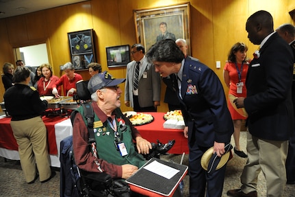 Maj. Gen. Peggy Poore, Air Force Personnel Center commander, talks with Andrew Roca, Veterans Administration Voluntary Service volunteer, during the 2014 National Salute to Veteran Patients Program Feb. 14 at San Antonio's Audie Murphy VA Hospital. (U.S. Air Force photo by Melissa Peterson)