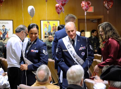 Staff Sgt. Kathryn North and Tech. Sgt. Daniel Anderson, 2014 Joint Base San Antonio Air Force military ambassadors, speak with veterans before the 2014 National Salute to Veteran Patients program Feb. 14 at Audie Murphy VA Hospital in San Antonio. The military ambassadors and Joint Base San Antonio military leaders distributed valentines and visited with veteran patients. Veterans’ Administration facilities across the United States pay tribute to veteran patients annually during this week-long salute. (U.S. Air Force photo by Airman 1st Class Alexandria Slade)