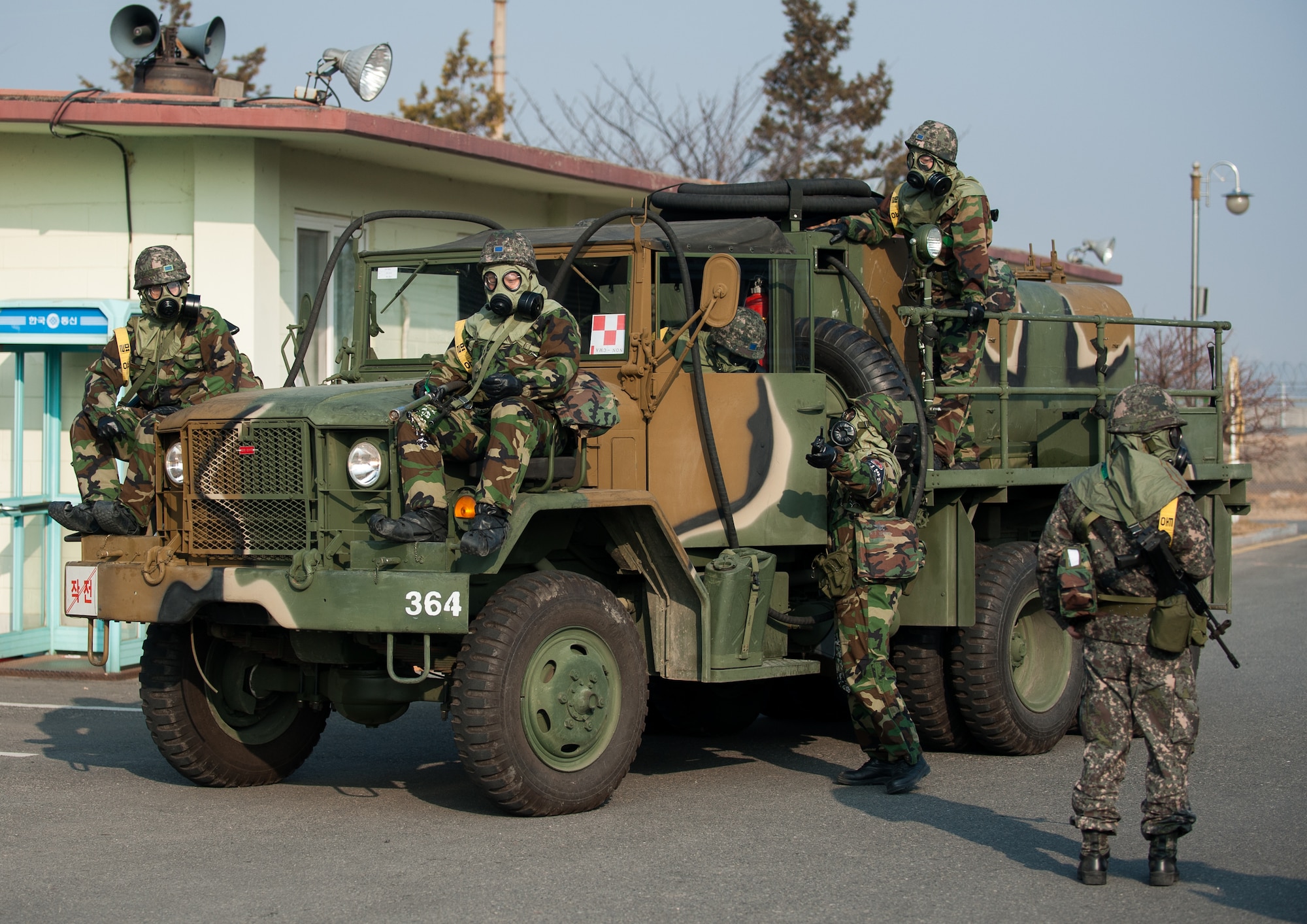 Republic of Korea airmen respond to a simulated fire during an exercise at Kunsan Air Base, Republic of Korea, Feb. 20, 2014. The exercise included a combined response from the 8th Civil Engineer Squadron fire department and the RoKaf 38th Fighter Group fire department. (U.S. Air Force photo by Staff Sgt. Clayton Lenhardt/Released)
