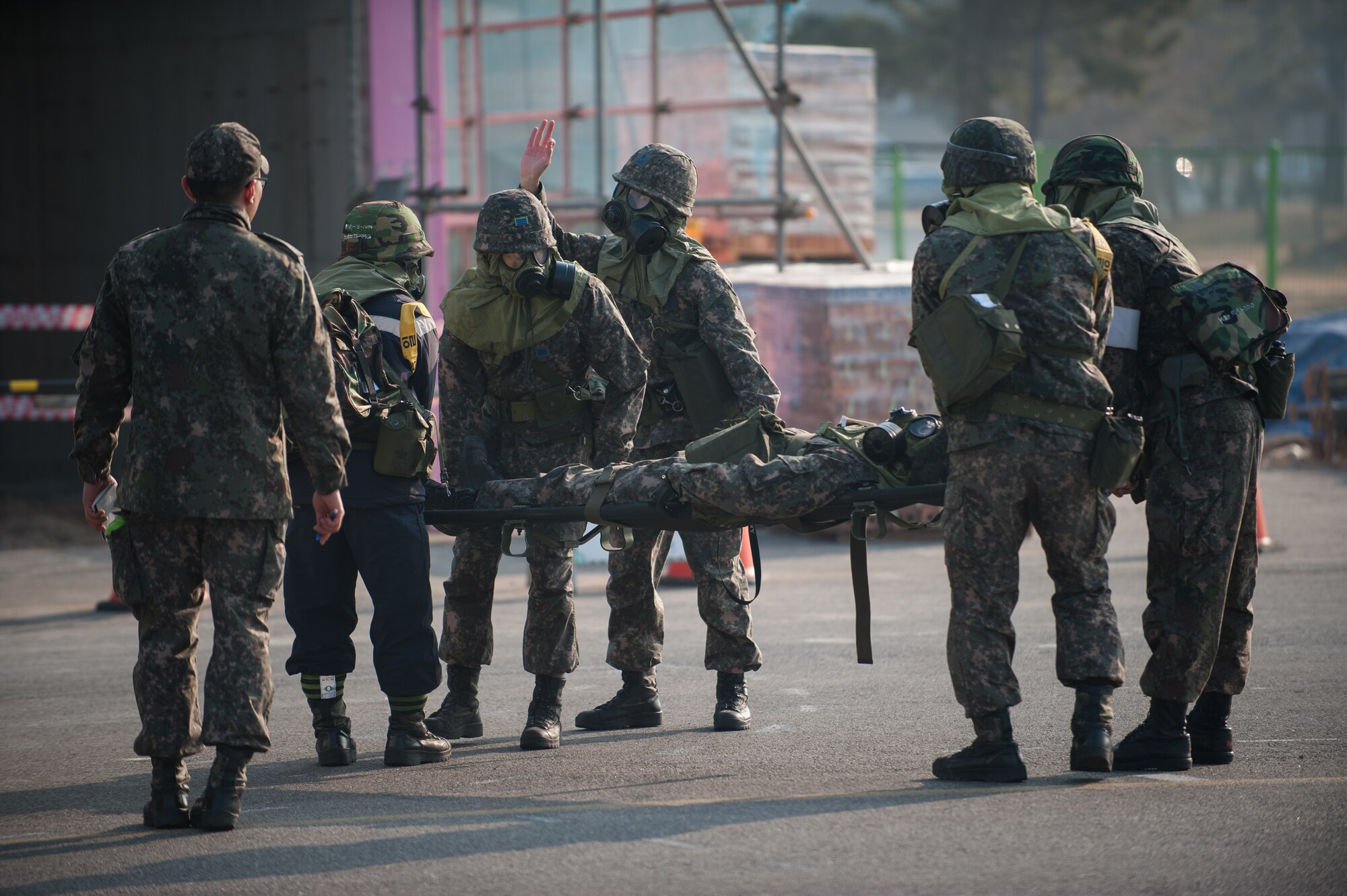 Republic of Korea airmen transport a simulated victim during an exercise at Kunsan Air Base, Republic of Korea, Feb. 20, 2014. The exercise included a combined response from the 8th Civil Engineer Squadron fire department and the RoKaf 38th Fighter Group fire department. (U.S. Air Force photo by Staff Sgt. Clayton Lenhardt/Released)