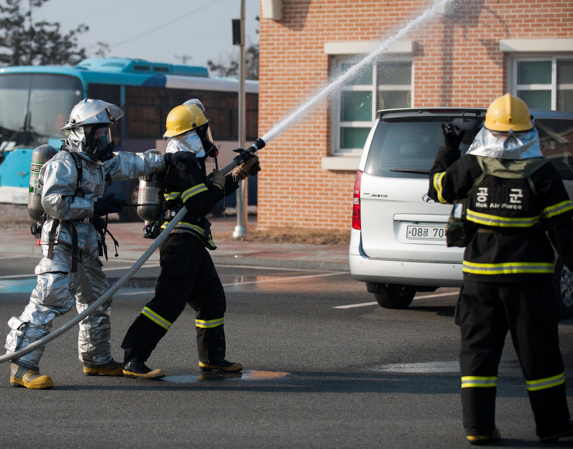 Firefighters from the 8th Civil Engineer Squadron and the Republic of Korea air force 38th Fighter Group respond to a simulated fire during a combined training exercise at Kunsan Air Base, Republic of Korea, Feb. 20, 2014. The exercise tested the Wolf Pack's and Rokaf's ability to respond to a fire together. (U.S. Air Force photo by Staff Sgt. Clayton Lenhardt/Released)