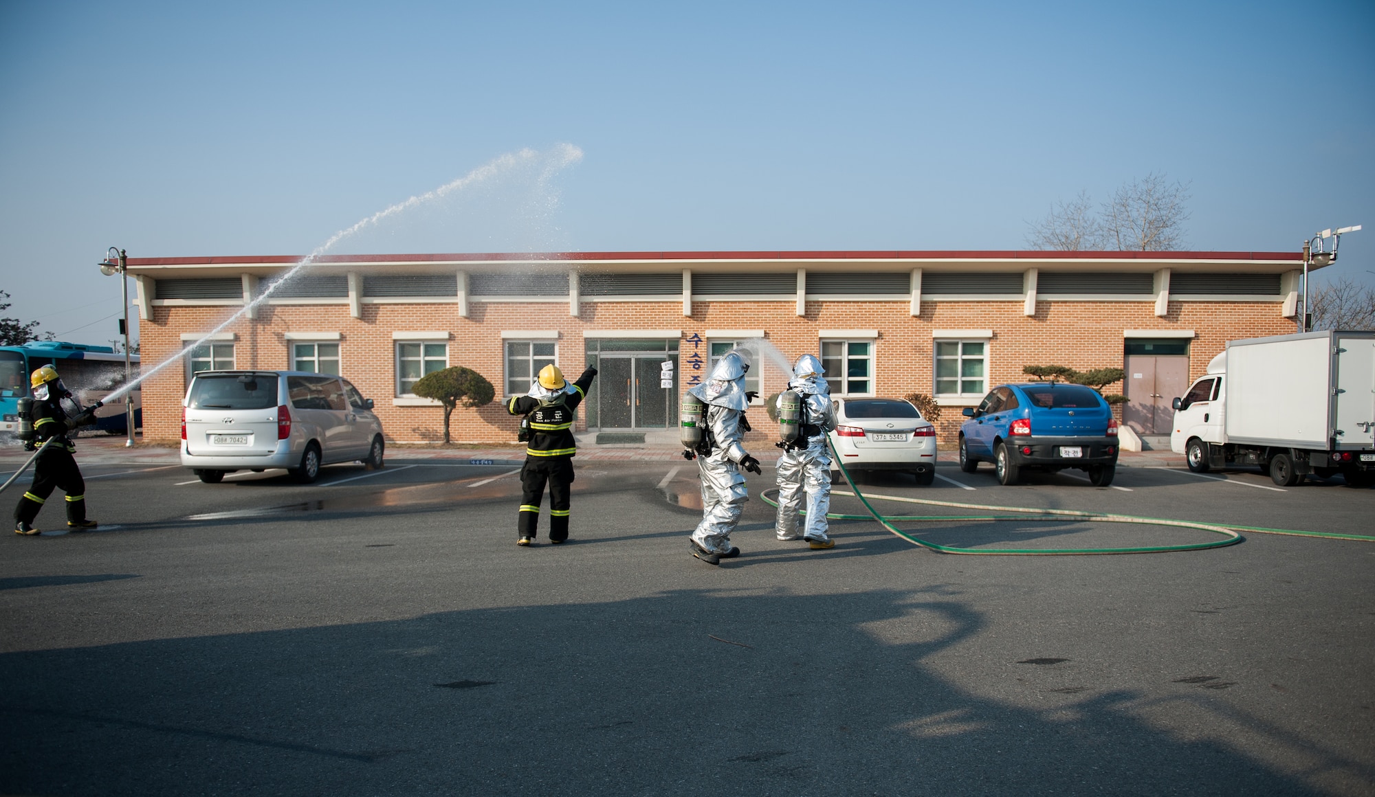 Firefighters from the 8th Civil Engineer Squadron and the Republic of Korea air force 38th Fighter Group respond to a simulated fire during a combined training exercise at Kunsan Air Base, Republic of Korea, Feb. 20, 2014. The exercise tested the Wolf Pack's and Rokaf's ability to respond to a fire together. (U.S. Air Force photo by Staff Sgt. Clayton Lenhardt/Released)