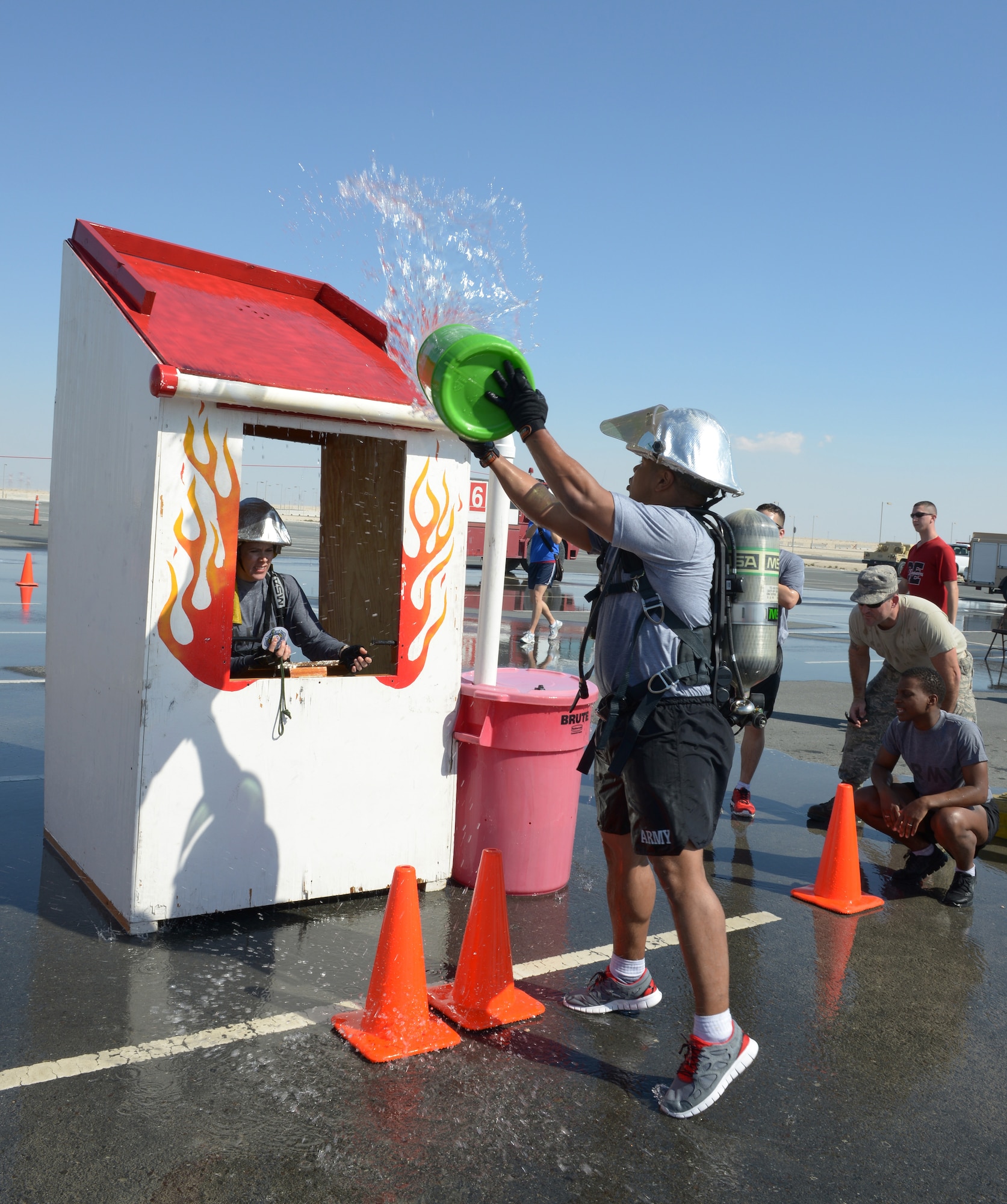 Soldiers deployed to Al Udeid Air Base, Qatar, compete in a fire muster Feb. 15, 2014. The fire muster is an obstacle course that consists of seven stations which each team must complete in less than five minutes. Ten teams of four people competed in the fire muster with the winning team completing the course with a time of three minutes and 16 seconds. (U.S. Air Force photo/Senior Airman Hannah Landeros)
