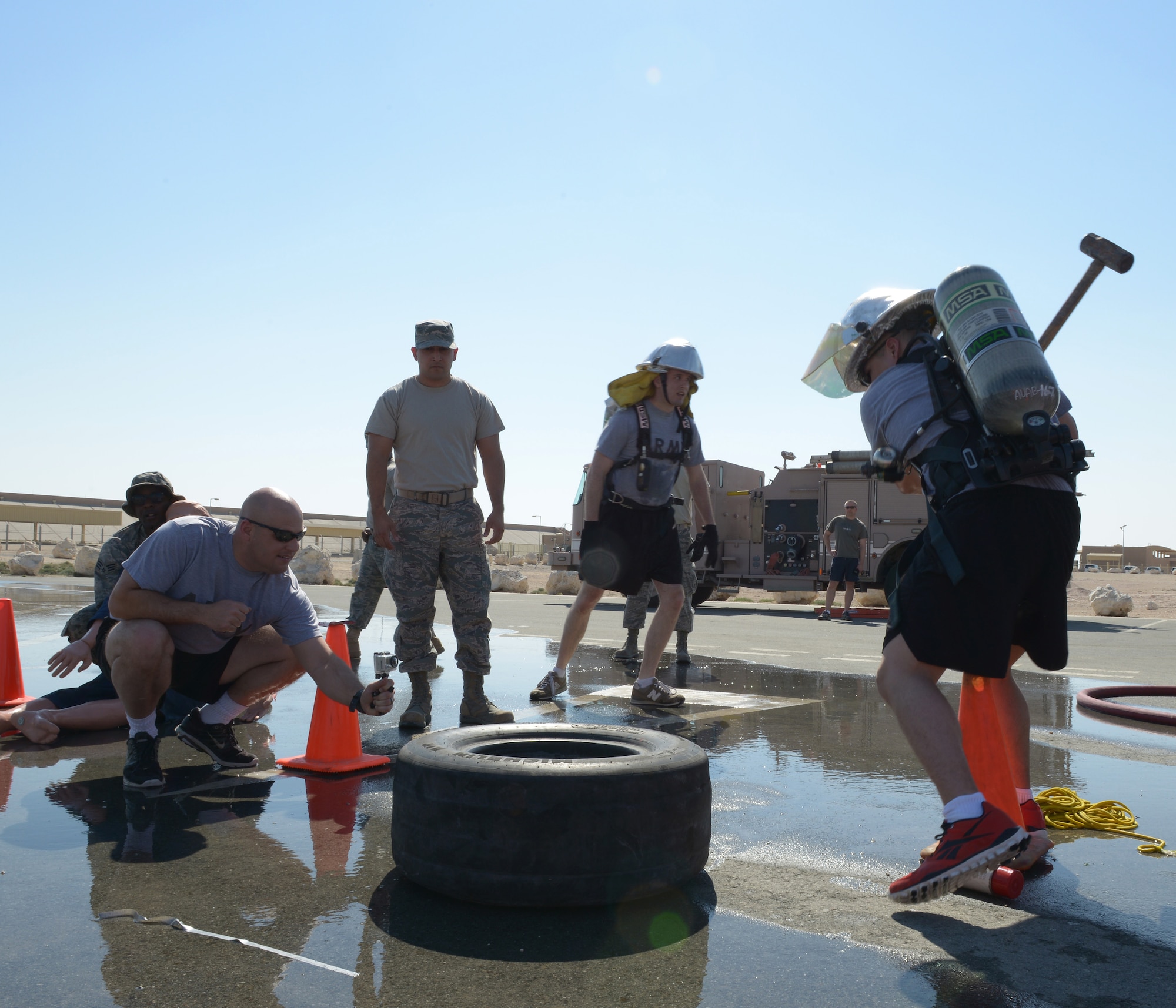 A team of soldiers compete in a fire muster competition at Al Udeid Air Base, Qatar, Feb. 15, 2014. The fire muster is an obstacle course that consists of seven stations which each team must complete in less than five minutes. Ten teams of four people competed in the fire muster with the winning team completing the course with a time of three minutes and 16 seconds. (U.S. Air Force photo/Senior Airman Hannah Landeros)