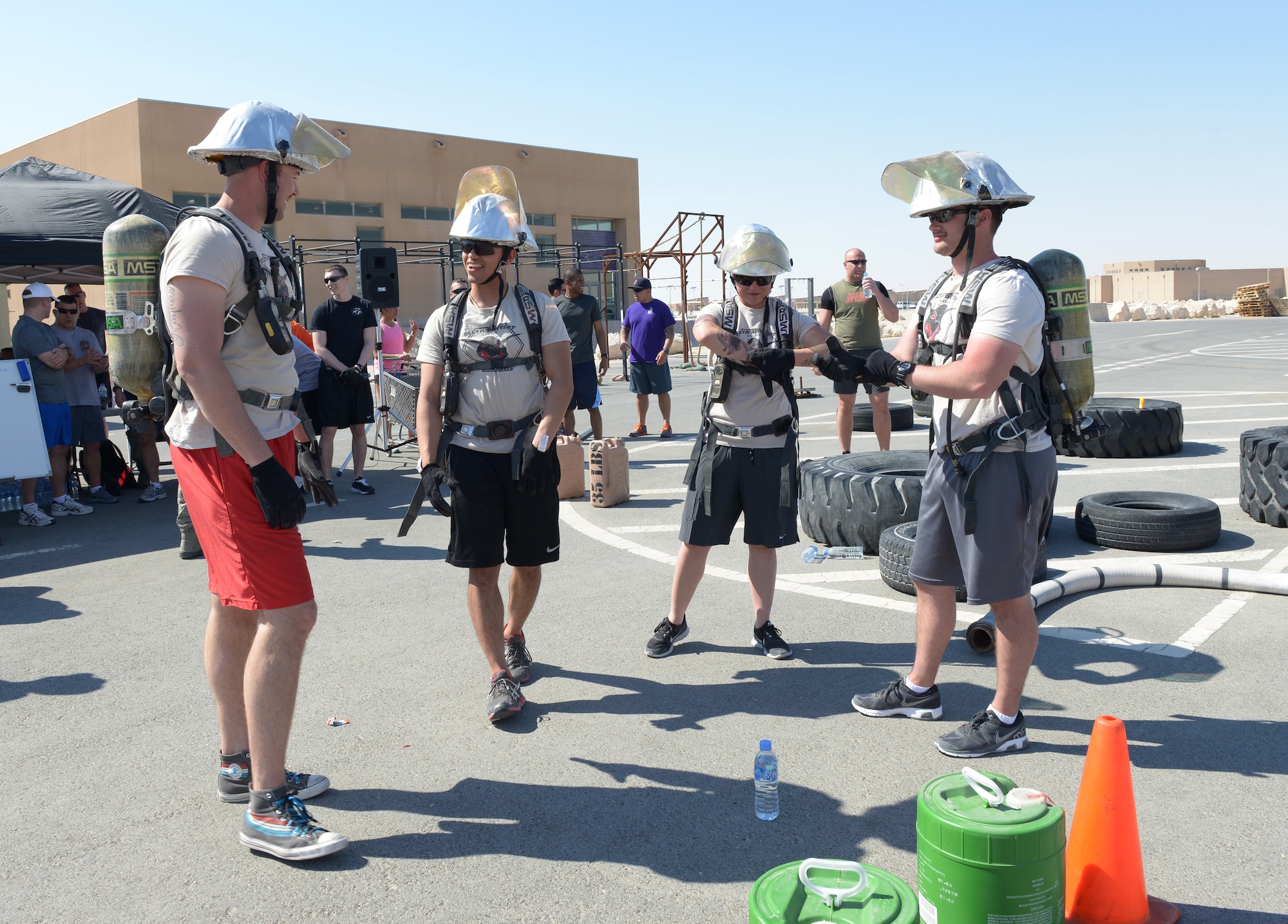 Airmen deployed to Al Udeid Air Base, Qatar, prepare to compete in a fire muster Feb. 15, 2014. The fire muster is an obstacle course that consists of seven stations which each team must complete in less than five minutes. Ten teams of four people competed in the fire muster with the winning team completing the course with a time of three minutes and 16 seconds. (U.S. Air Force photo/Senior Airman Hannah Landeros)