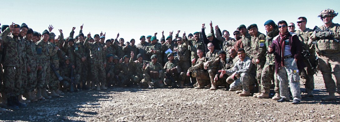 Afghan army engineers assigned to the 203rd Thunder Corps and U.S soldiers pose for a photograph to mark the first anniversary of the 203rd Thunder Corps Engineer Kandak on Forward Operating Base Thunder in Afghanistan's Paktya province, Feb. 17, 2014.