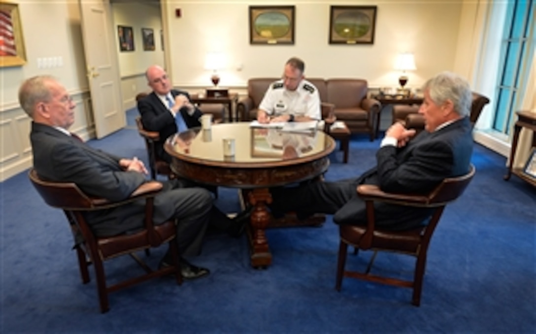 Defense Secretary Chuck Hagel, right, meets with retired Air Force Gen. Larry D. Welch, left, and retired Navy Adm. John C. Harvey Jr., second from left, at the Pentagon, Feb. 19, 2014. Welch and Harvey will begin an independent review of the Defense Department's nuclear enterprise to correspond with an internal review, responding to revelations of irregularities within the nuclear enterprise. Army Lt. Gen. Robert B. Abrams, the secretary's senior military assistant, second from right, attends the meeting. Note: This image has been altered for operational security purposes.
