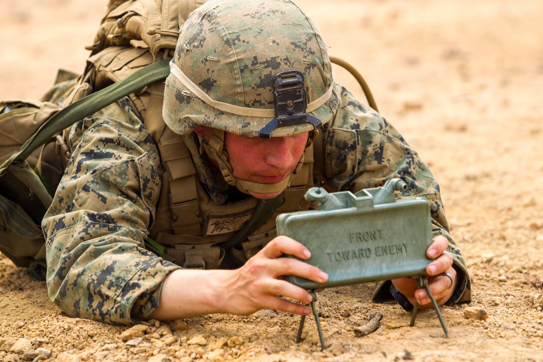 Lance Cpl. Dominique A. Sparacino sets up an M18A1 claymore mine Feb. 14 at Ban Chan Krem, Kingdom of Thailand during Exercise Cobra Gold. The day’s training was intended to practice and demonstrate how to properly and safely employ various explosive charges. Sparacino is an infantry assaultman with 3rd Battalion, 1st Marine Regiment, which is currently assigned to 4th Marines, 3rd Marine Division, III Marine Expeditionary Force, as part of the Marine Corps’ unit deployment program. (U.S. Marine Corps photo by Cpl. Adam B. Miller/Released)