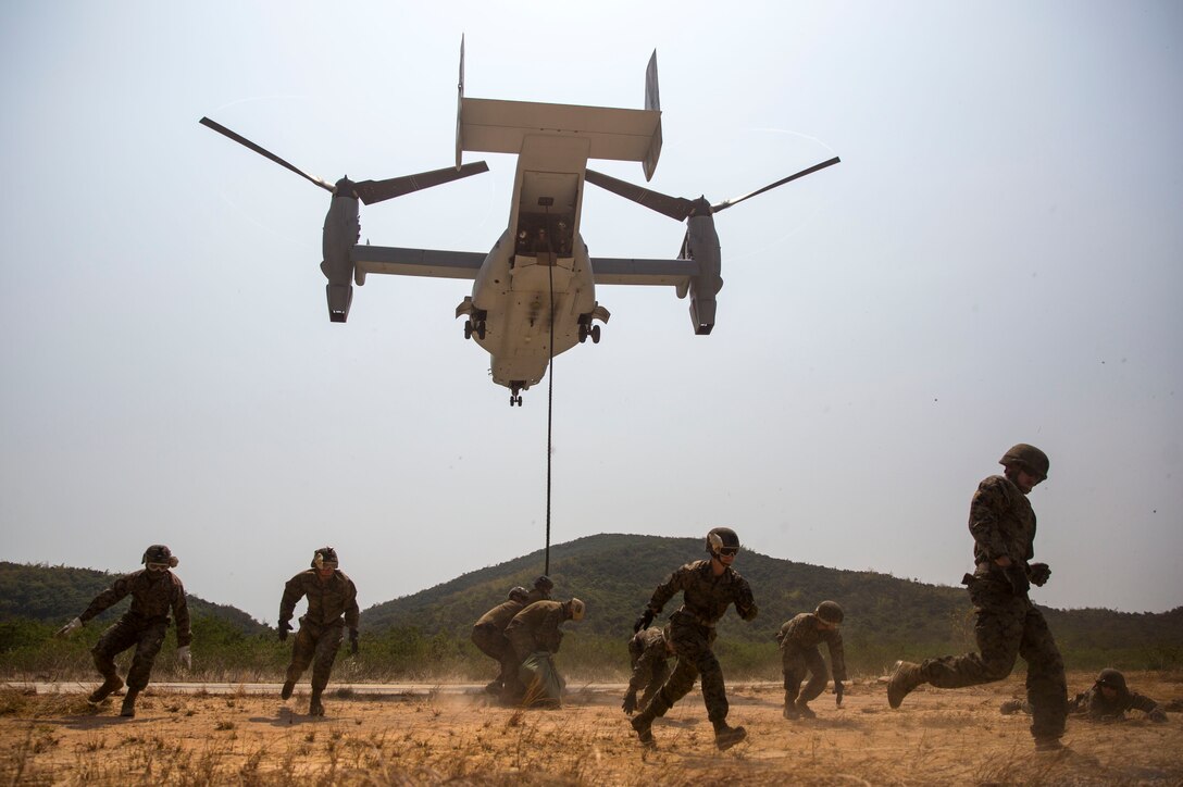 U.S. Marines evacuate the area as an MV-22B Osprey comes into land at Hat Yao, Kingdom of Thailand Feb. 18 during Exercise Cobra Gold 2014. Cobra Gold, in its 33rd iteration, is designed to advance regional security and ensure effective response to regional crises by exercising a robust multinational force from nations sharing common goals and security commitments in the Asia-Pacific region. The Marines are with 3rd Reconnaissance Battalion, 3rd Marine Division, III Marine Expeditionary Force and Headquarters Battalion, 3rd Marine Division, III Marine Expeditionary Force. (U.S. Marine Corps photo by Cpl. Zachary W Scanlon/Released)