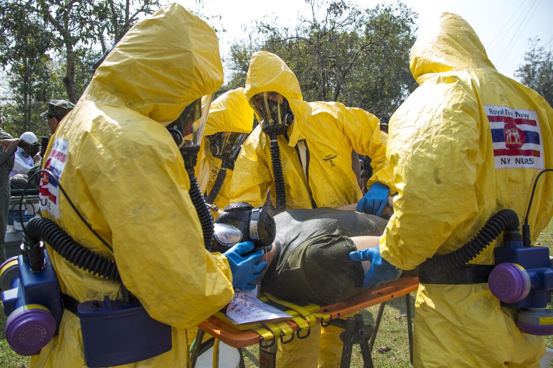 Royal Thai Navy first receivers decontaminate a U.S. service member who was a mock victim from a simulated chemical terrorist attack during the counter weapons of mass of destruction exercise aboard Wing One Royal Thai Air Force Base, Nakhon Ratchasima, Kingdom of Thailand, Feb. 16 during Exercise Cobra Gold 2014. CG 14 is a joint, multinational exercise conducted annually in the Kingdom of Thailand aimed at enhancing and increasing mission readiness and multinational interoperability. The U.S. service member is with 1st Marine Aircraft Wing, III Marine Expeditionary Force. (U.S. Marine Corps photo by Cpl. James R. Smith/Released)