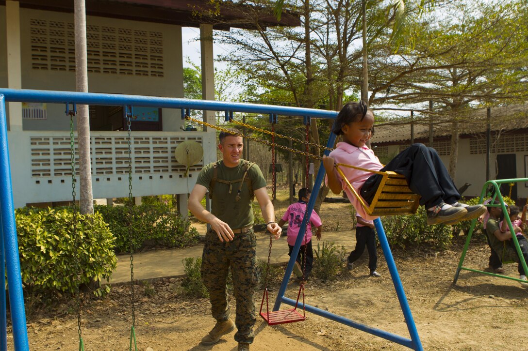 U.S. Navy Lt. Ryan Williams pushes Prae, Feb. 11 at the Wut Khun Song elementary school near Ban Chan Krem, Kingdom of Thailand during Exercise Cobra Gold 2014. The purpose of the community relations event was to have U.S. Marines and sailors teach the elementary students English, play games and share parts of their culture while also learning about the Thai culture in the process. Prae is an 8 year old, 2nd grade student at the school. Williams is a chaplain with 3rd Battalion, 1st Marine Regiment. 3rd Battalion, 1st Marines is attached to 4th Marines, 3rd Marine Division, III Marine Expeditionary Force, as part of the Marine Corps’ unit deployment program. (U.S. Marine Corps photo by Cpl. Adam B. Miller/Released)