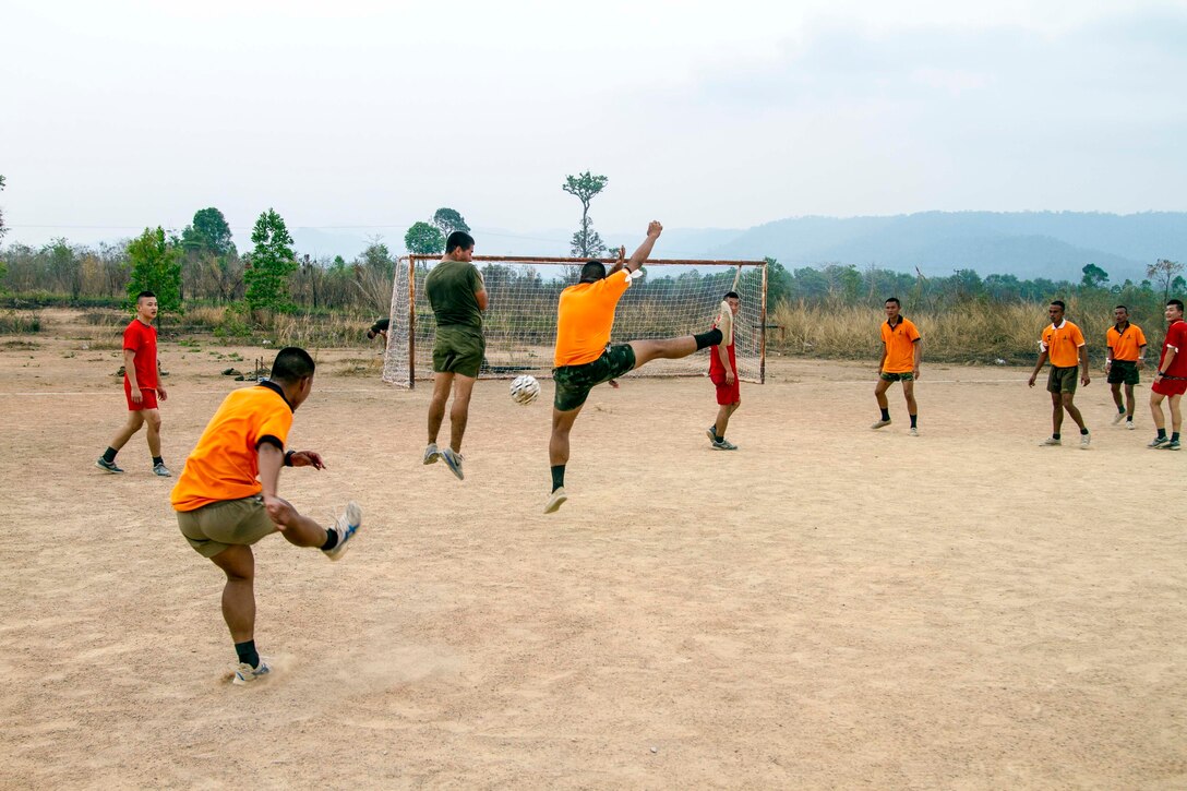 A Royal Thai Marine places the ball between two defenders in an attempt to score during a friendly game of soccer Feb. 16 at Ban Chan Krem, Kingdom of Thailand during Exercise Cobra Gold. Ban Chan Krem is hosting field training exercises that will enhance interoperability and strengthen regional relationships between the Republic of Thailand, Republic of Korea and the United States. The Royal Thai Marines are with 3rd Company, 7th Battalion of the Royal Thai Marine Corps. The U.S. Marines are with 3rd Battalion, 1st Marine Regiment currently assigned to 4th Marine Regiment, 3rd Marine Division, III Marine Expeditionary Force under the unit deployment program. (U.S. Marine photo by Lance Cpl. Stephen D. Himes/Released)