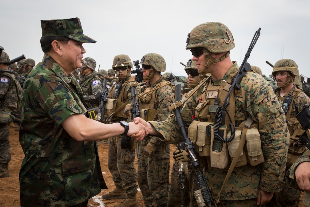 Royal Thai General Thanasaka Patimaprakorn shakes hands with a U.S. Marine after the completion of a combined live-fire exercise for the conclusion of exercise Cobra Gold 2014 at Royal Thai Navy Tactical Training Center Ban Chan Krem, Chanthaburi, Kingdom of Thailand, Feb. 15. Cobra Gold, in its 33rd iteration, demonstrates the U.S. and the Kingdom of Thailand's commitment to our long-standing alliance and regional partnership, prosperity and security in the Asia-Pacific region. Patimaprakorn is the chief of defense forces for the Royal Thai Armed Forces. (U.S. Marine Corps photo by Sgt. Matthew Troyer/Released)