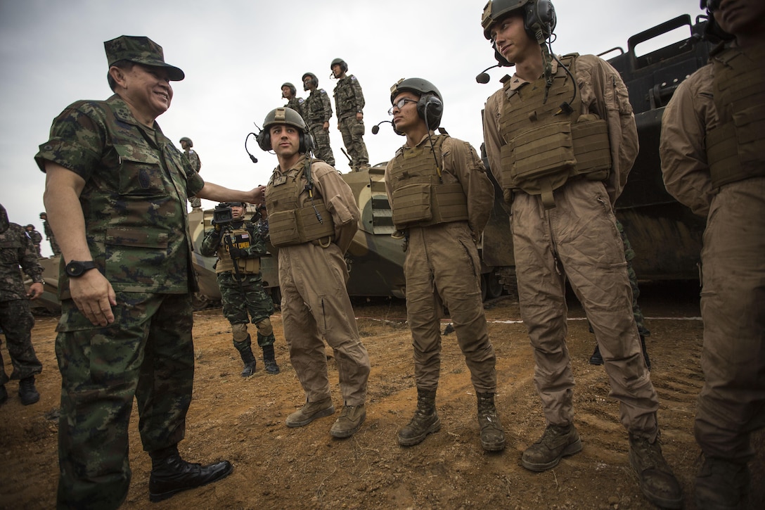 Royal Thai General Thanasaka Patimaprakorn speaks with U.S. Marines after the completion of a combined live-fire exercise during the conclusion of exercise Cobra Gold 2014 in Royal Thai Navy Tactical Training Center Ban Chan Krem, Chanthaburi, Kingdom of Thailand, Feb. 21. Cobra Gold, in its 33rd iteration, demonstrates the U.S. and the Kingdom of Thailand's commitment to our long-standing alliance and regional partnership, prosperity and security in the Asia-Pacific region. (U.S. Marine Corps photo by Sgt. Matthew Troyer/Released)