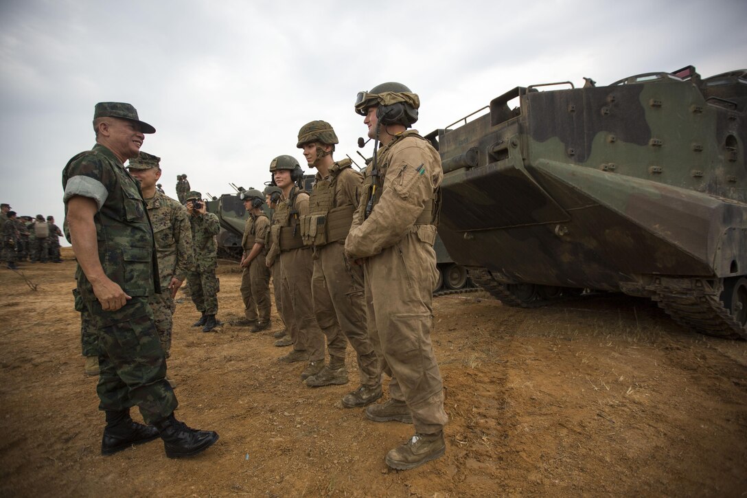 Royal Thai General Thanasaka Patimaprakorn speaks with U.S. Marines after the completion of a combined live-fire exercise during the conclusion of exercise Cobra Gold 2014 in Royal Thai Navy Tactical Training Center Ban Chan Krem, Chantaburi, Kingdom of Thailand, Feb. 21. Cobra Gold, in its 33rd iteration, demonstrates the U.S. and the Kingdom of Thailand's commitment to our long-standing alliance and regional partnership, prosperity and security in the Asia-Pacific region. Patimaprakorn is the Chief of Defense Forces for the Royal Thai Armed Forces. (U.S. Marine Corps photo by Sgt. Matthew Troyer/Released)