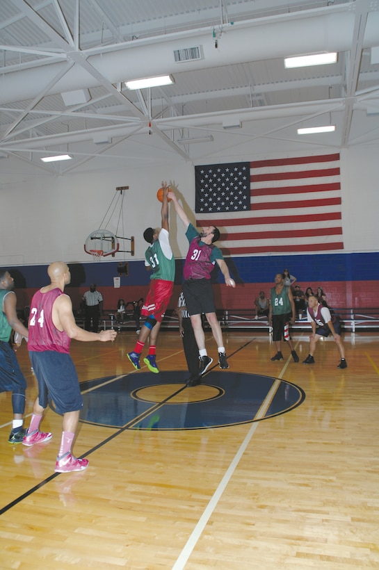 Daryne Lucas, Outsiders, left, and Derek Otten, Tufels, compete for possession of a jump ball to start the intramural basketball game Tuesday at Thomason Gymnasium, Tuesday.