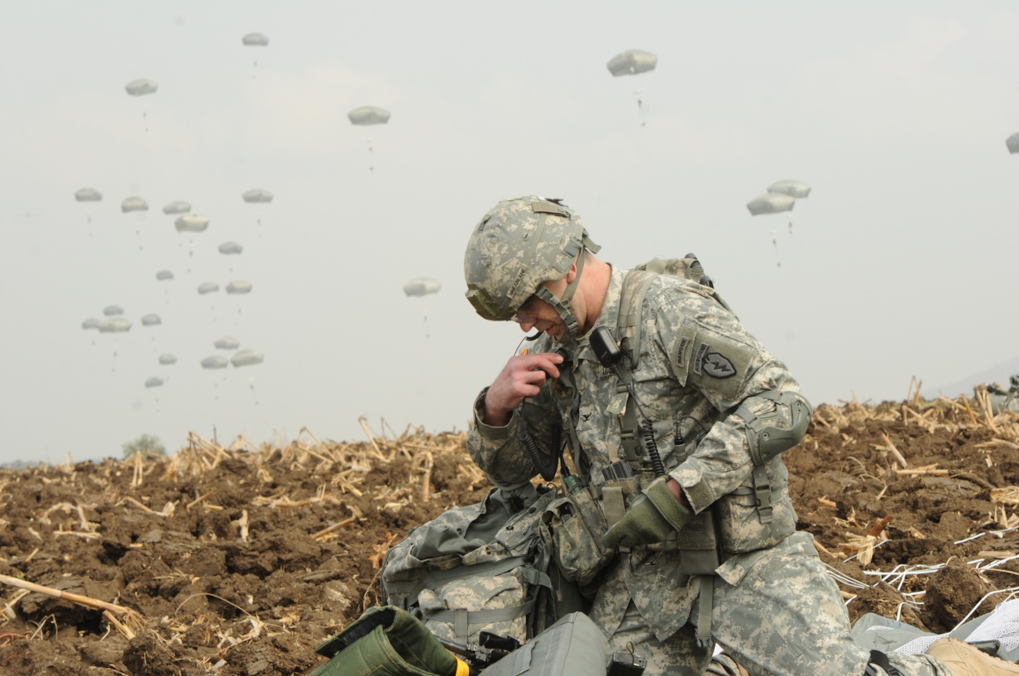 Army Col. Matt McFarlane gathers his equipment after successfully parachuting into Lop Buri, Kingdom of Thailand, after traveling from Alaska with approximately 400 paratroopers and 20 Royal Thai Armed Forces liaisons Feb. 14, 2014, as part of Exercise Cobra Gold. Cobra Gold, an annual exercise providing tactical, humanitarian and civil assistance, brings together multiple nations cooperating in areas of common interest to support the security and stability of the Asia-Pacific region. McFarlane is the commander of the 4th Infantry Brigade Combat Team (Airborne) from the 25th Infantry Division. (U.S. Army photo/Staff Sgt. Jeffrey Smith)