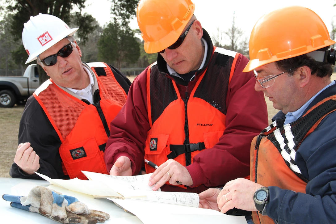 Joel Scussel (left), Norfolk District’s project manager for the Great Bridge Lock here, reviews plans for the gate removal with contractors from U.S. Facilities, Inc., based in Philadelphia, Pa. The last set of gates were installed 25 years ago, and once a set of gates are removed, they are refurbished and will be cycled back into the locks as other gates are cycled out. 