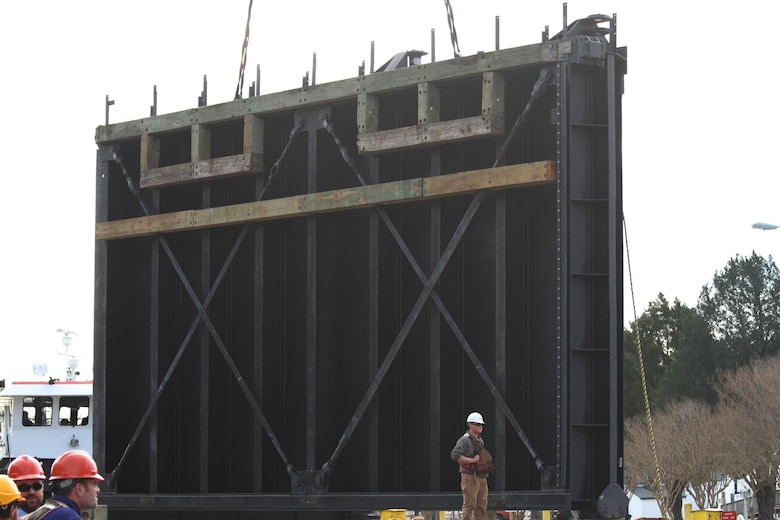 One of two refurbished lock gates is lowered into the canal at the Great Bridge Lock Feb. 20, 2014. The 72-ton set of aging lock gates were removed after 25 years and are being replaced with refurbished gates - part of a service plan to increase the lifespan of the Great Bridge locks. Each set of canal gates, which are managed and operated by the Norfolk District, is removed and refurbished on a rotational basis every 15 to 20 years. 