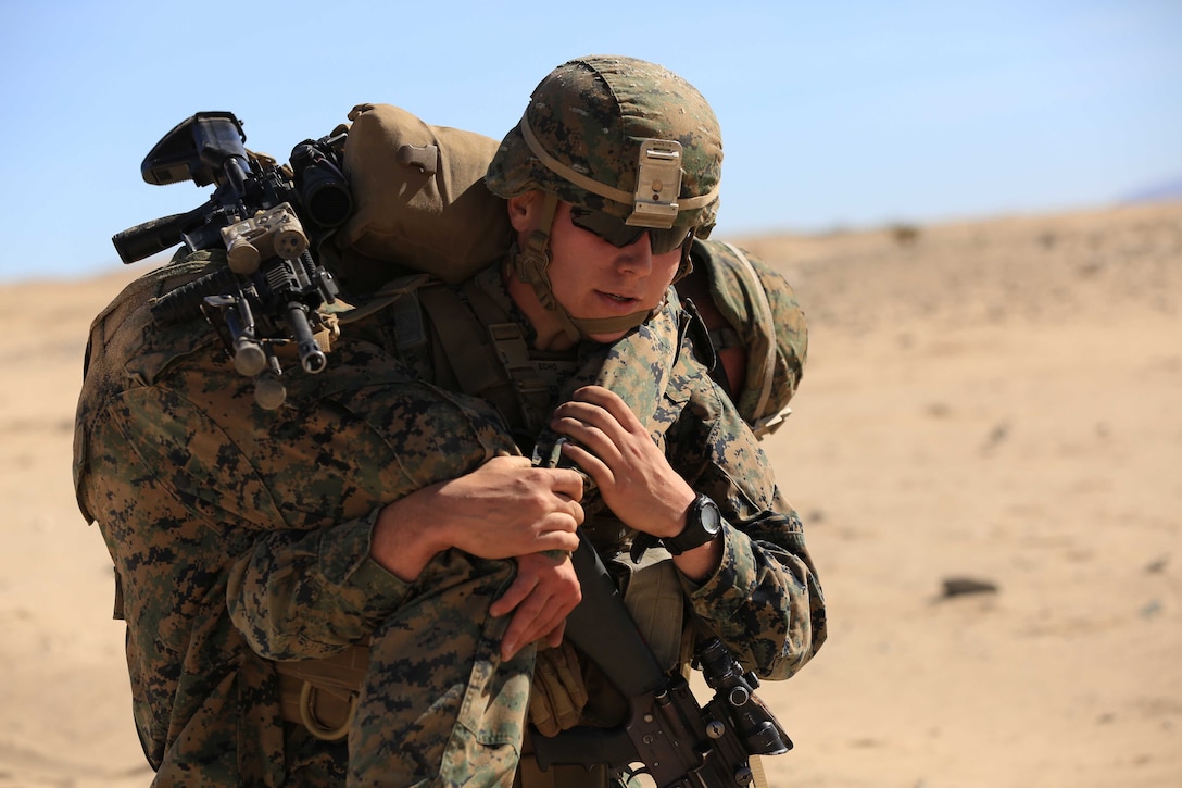 A Marine with Company E, 2nd Battalion, 7th Marine Regiment, conducts a fireman carry with a fellow Marine during a squad competition aboard the Combat Center Feb. 12, 2014. With field training refreshers, the company reinforced infantry tactics in an operational environment.


