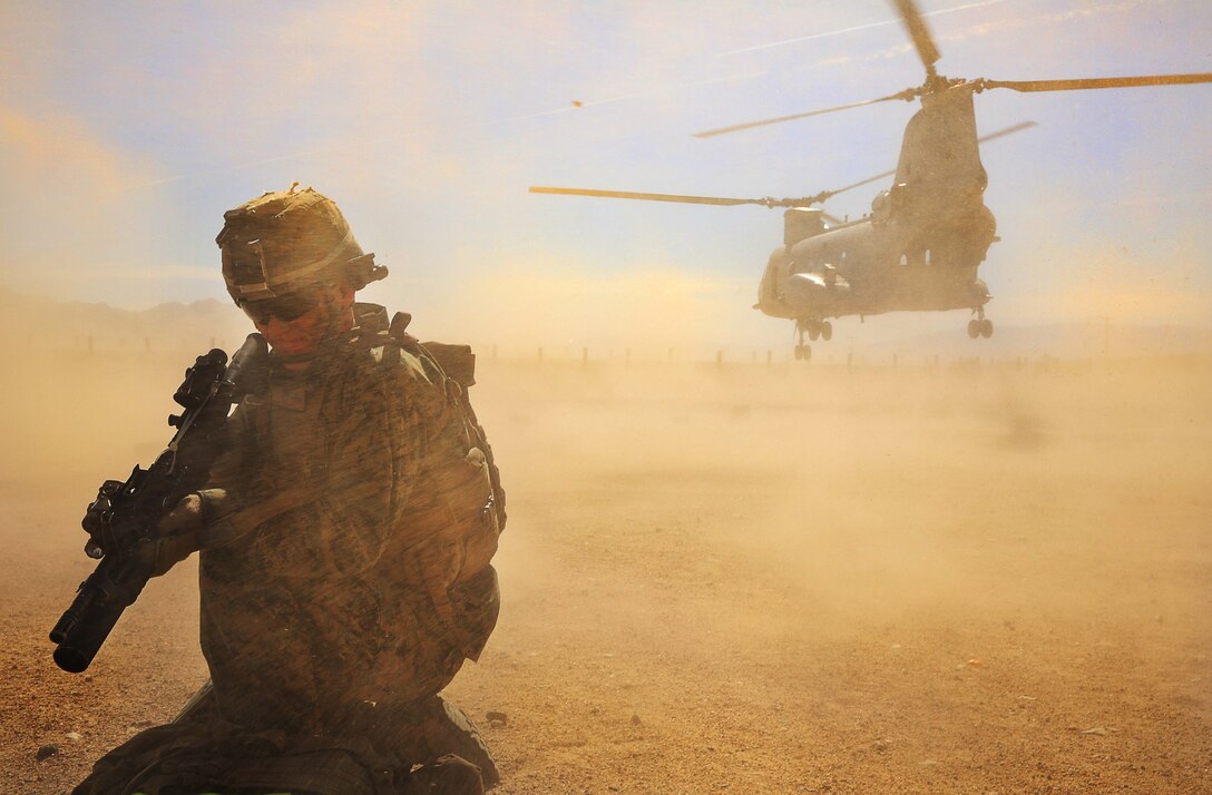 A Marine with Company E, 2nd Battalion, 7th Marine Regiment, disembarks a CH-46 Chinook helicopter aboard Range 701 as part of a squad competition aboard the Combat Center Feb. 12, 2014. Marines with the company executed physical and mental infantry techniques to navigate the nearly 10-mile course.


