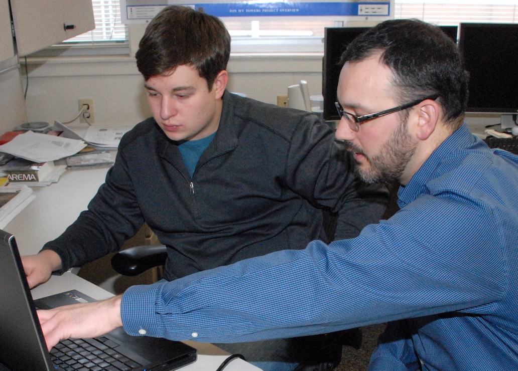 Mike Alley, civil engineer in the Design Branch at the Alaska District, instructs Jarrett Oney Feb. 18 about a storm water outfall on Kodiak Island. Alley is mentoring Oney who is a local high school student and member of the Anchorage School District Gifted Mentorship Program. Alley's passion for teaching led him to volunteer his time and expertise to the program.