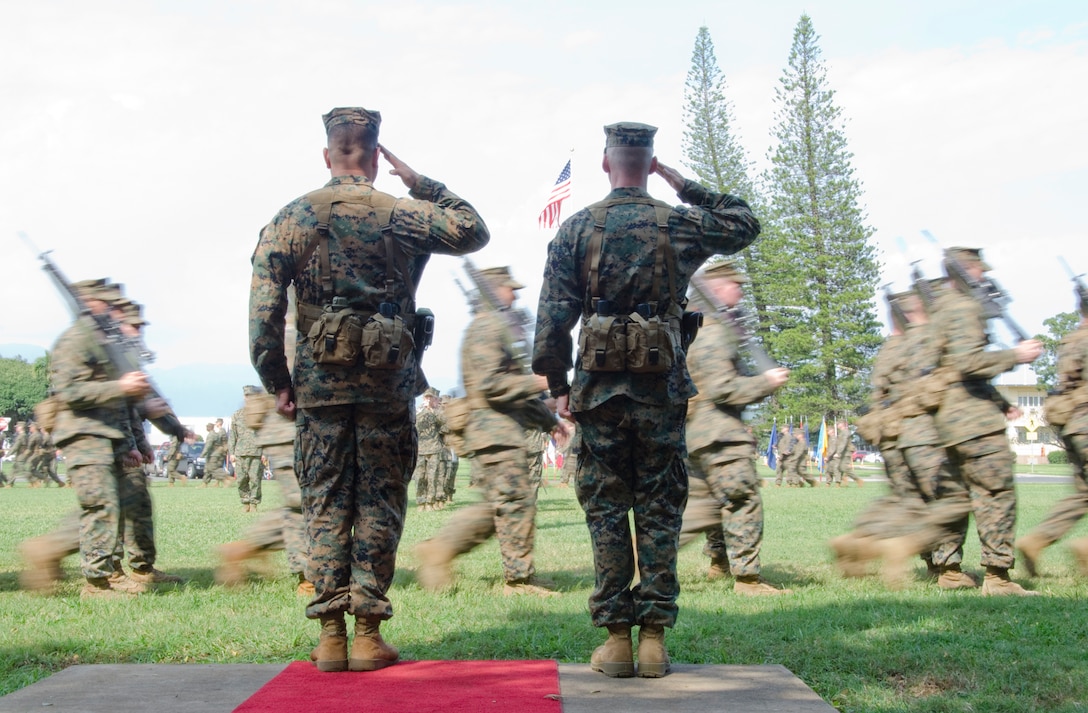 Lt. Col. Thomas D. Wood (left), outgoing commanding officer, and Lt. Col. Matthew W. Tracy, incoming commanding officer, 3rd Battalion, 3rd Marine Regiment, render salutes as Marines and sailors conduct the pass in review portion of the change of command ceremony, Feb. 13, 2014. (U.S. Marine Corps photo by Kristen Wong)