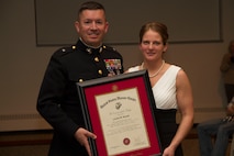 Brig. Gen. James W. Bierman, Commanding General, Western Recruiting Region, presents the Commandant’s Trophy to officer Candidate Louise M. Nowak at Carroll University, Feb. 21, 2014. Candidate Nowak was selected above her peers to receive the Commandant’s Trophy in recognition of her superior academic performance, physical ability and exceptional leadership skills.