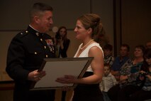Brig. Gen. James W. Bierman, Commanding General, Western Recruiting Region, presents the Commandant’s Trophy to officer Candidate Louise M. Nowak at Carroll University, Feb. 21, 2014. Candidate Nowak was selected above her peers to receive the Commandant’s Trophy in recognition of her superior academic performance, physical ability and exceptional leadership skills.