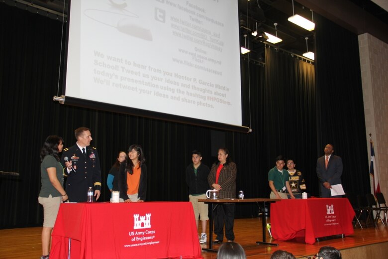 Students from Hector P. Garcia Middle School take part in a science experiment as part of a science, technology, engineering and math presentation by Southwestern Division Commander, Brig. Gen. Thomas Kula and Representative Mark Veasey.