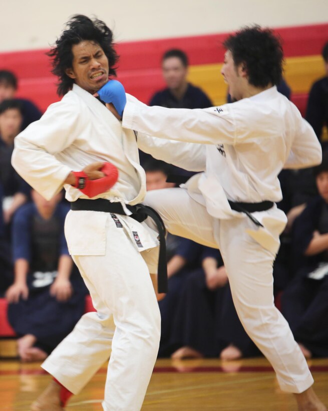 A Nippon Sport Science University karate athlete and a local karate champion display fighting techniques in a karate match during a demonstration of traditional Japanese performing and martial arts for Marine Corps Base Hawaii at the Semper Fit Center gym, Feb. 13, 2014. (U.S. Marine Corps photo by Lance Cpl. Suzanna Knotts)