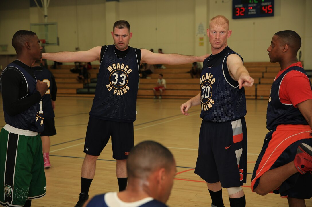 Chief Warrant Officer Timothy Gardner, communication-electronics maintenance officer, 1st Tank Battalion, chooses the next four players to go on the court during a basketball game at the East Gym, Feb. 6, 2014.

