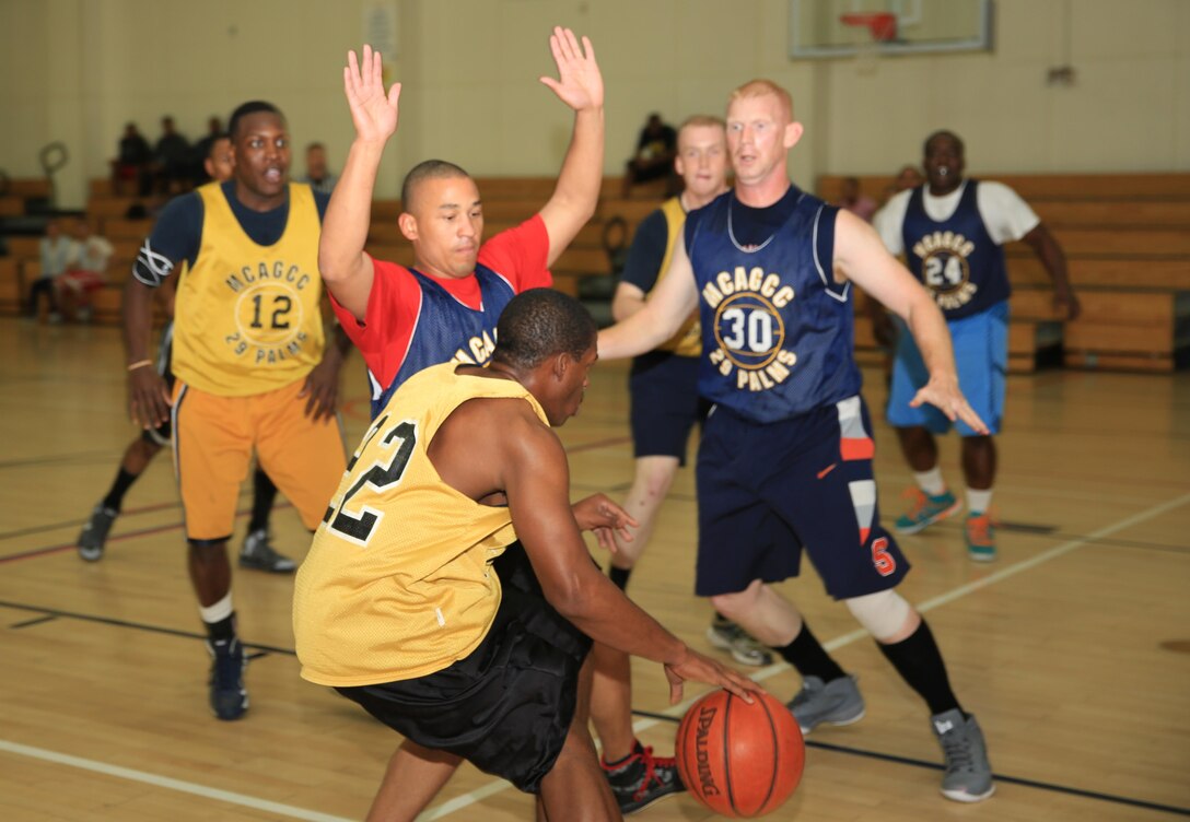 Chief Warrant Officer Timothy Gardner, communication-electronics maintenance officer, 1st Tank Battalion, sets up defense during a basketball game at the East Gym, Feb. 6, 2014. The Basketball League began Jan. 6 aboard the Combat Center and was hosted by Marine Corps Community Services Sports.


