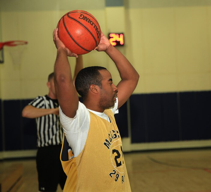 Pfc. Forrest Nett, student, Marine Corps Communication-Electronics School, prepares to pass the ball during a basketball game at the East Gym, Feb. 8, 2014. Nett recovered the ball and made it to the opposing team's hoop to score.