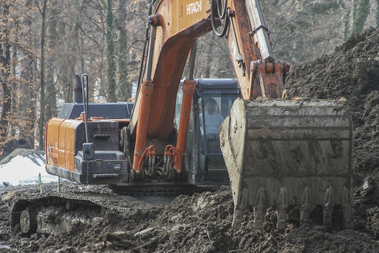 ARLINGTON, Va. -- Construction crews move dirt and prepare the ground at the Arlington National Cemetery Millennium Expansion Project, Feb. 19, 2014. The 27-acre project will add nearly 30,000 burial and niche spaces with a mix of above-ground columbariums and in-ground burials. The project also involves restoring an impaired stream that runs through the area. (U.S. Army photo/Patrick Bloodgood)