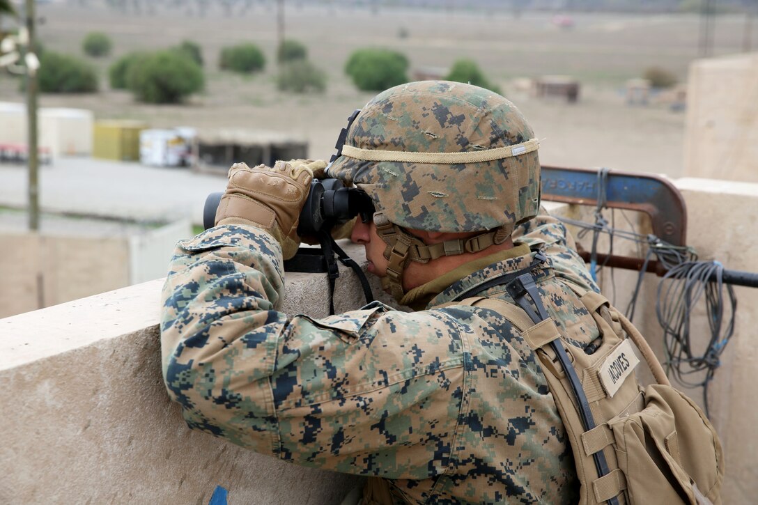 Lance Cpl. Nick Jacoves, a rifleman with the 11th Marine Expeditionary Unit’s ground combat element, 2nd Battalion, 1st Marines, and a Long Island Beach, N.J. native, observes the surrounding area during the Crisis Response Course, Special Operations Training Group, I Marine Expeditionary Force, here Feb.19. The course simulated the reinforcement of a consulate in the Pacific region, a potential mission during the 11th MEU’s deployment later this summer.