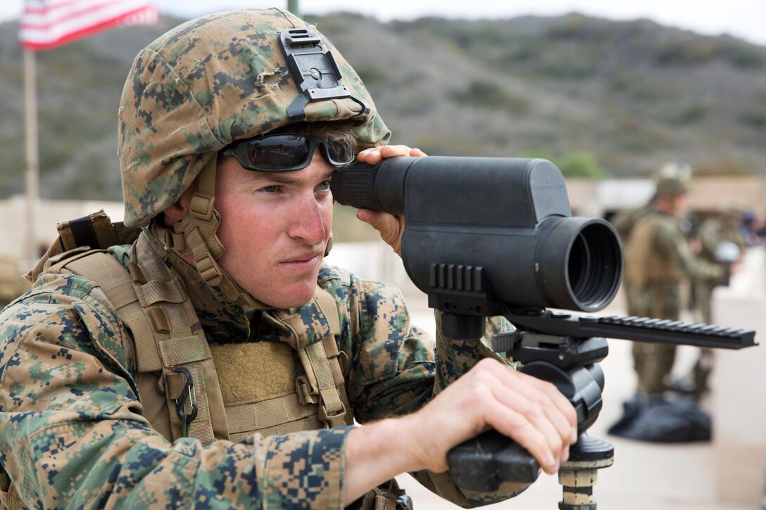 Lance Cpl. John Lemar, a scout sniper with the 11th Marine Expeditionary Unit’s ground combat element, 2nd Battalion, 1st Marines, and a Hartsville, Tenn. native, searches the area for notable activity during the Crisis Response Course, Special Operations Training Group, I Marine Expeditionary Force, here Feb.19. The course simulated the reinforcement of a consulate in the Pacific region, a potential mission during the 11th MEU’s deployment later this summer.