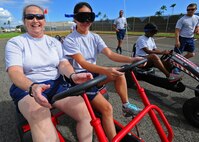 Airmen from the 15th Medical Group struggle to drive as they take part in a driving simulation game while wearing goggles that replicate the effects of alcohol during the group’s Wingman Day at Joint Base Pearl Harbor-Hickam, Hawaii, Feb. 20, 2014. The event highlighted the dangers of drinking and driving and the consequences associated with it. (U.S. Air Force photo/Master Sgt. Jerome S. Tayborn)