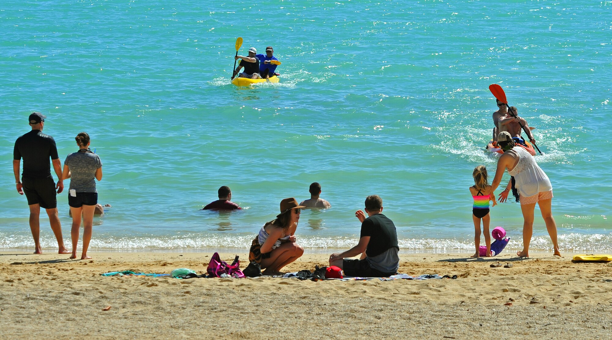 Airmen from the 96th Air Refueling Squadron participate in a kayak race as their coworkers and family members cheer them on during the 96th ARS Wingman Day at Hickam Beach on Joint Base Pearl Harbor-Hickam, Hawaii, Feb. 20, 2014. The squadron spent their day participating in activities that fostered togetherness and teamwork. (U.S. Air Force photo/Master Sgt. Jerome S. Tayborn)