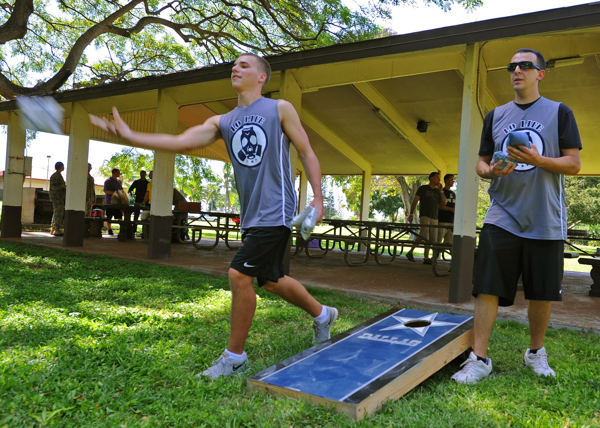 Airmen from the 15th Maintenance Group compete in a corn-hole competition during the group’s Wingman Day at Joint Base Pearl Harbor-Hickam, Hawaii, Feb. 20, 2014. Wingman Day highlights the importance of being a good teammate, wingman and the importance of making smart decisions. (U.S. Air Force photo/Master Sgt. Jerome S. Tayborn)