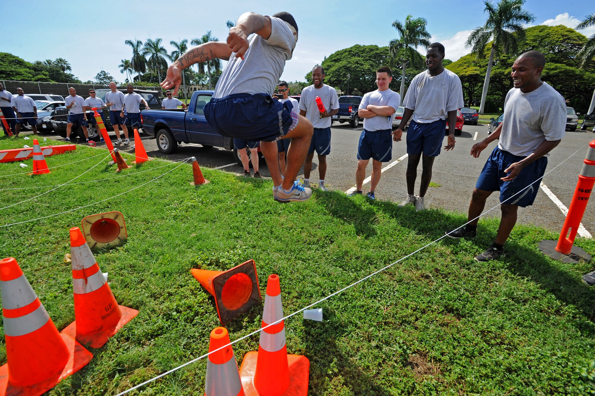 Airmen from the 647th Civil Engineer Squadron help guide a fellow blindfolded Airmen through a simulated land mine obstacle course during the 647th CES Wingman Day at Joint Base Pearl Harbor-Hickam, Hawaii, Feb. 19, 2014. Wingman Day encourages teamwork, and highlights the Air Force’s focus on its most valuable asset: Airmen. (U.S. Air Force photo/Master Sgt. Jerome S. Tayborn)