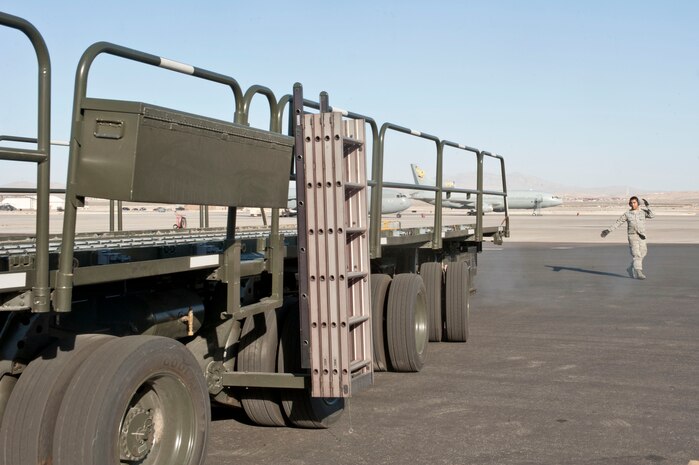 U.S. Air Force Staff Sgt. Chris Alvarez, 99th Logistics Readiness Squadron air transportation craftsman, guides a 60K Tunner loader on the flightline Feb. 19, 2014, at Nellis Air Force Base, Nev. The 99th LRS air terminal staff use a 60K Tunner loader to transport pallets of cargo to and from cargo aircraft. (U.S. Air Force photo by Senior Airman Matthew Lancaster)