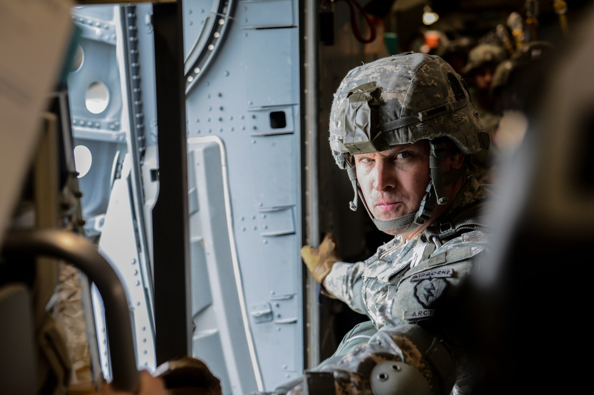 Army 1st Sgt. Jason Woodbury, a 3rd Battalion (Airborne), 509th Infantry Regiment jumpmaster, waits for the loadmaster's signal to jump from a C-17 Globemaster III, over Lop Buri, Thailand in support of Exercise Cobra Gold 2014. CG14, in its 33rd iteration, demonstrates the U.S. and the Kingdom of Thailand's commitment to their long-standing alliance and regional partnership, prosperity and security in the Asia-Pacific region. (U.S. Air Force photo/Tech. Sgt. Sean Tobin)