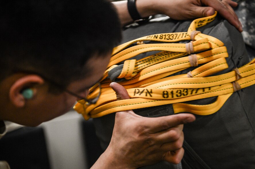 A jumpmaster from the 4th Infantry Brigade Combat Team (Airborne), 25th Infantry Division inspects the static line of another 4/25 Soldier, Feb. 15, 2014, prior to a combined U.S. and Thai armed forces jump into Lopburi, Thailand, for Exercise Cobra Gold 2014. CG14, in its 33rd iteration, demonstrates the U.S. and the Kingdom of Thailand's commitment to their long-standing alliance and regional partnership, prosperity and security in the Asia-Pacific region. (U.S. Air Force photo/Tech. Sgt. Sean Tobin)