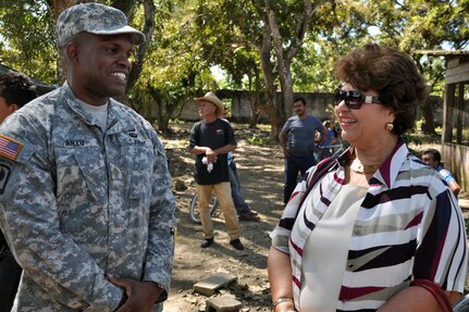 U.S. Army Maj. Juan Arzu visits with Maria Luisa Martell de Matute, Vice-Mayor of Puerto Cortez during a visit to an ongoing Medical Readiness and Training Exercise (MEDRETE) being conducted in the town of Caoba, Department of Cortes, Honduras, Feb. 20, 2014.  Several key leaders from Joint Task Force-Bravo met with Honduran military and civic leaders at the site to observe the medical relief mission and engage in discussion on how to build on the strong relationship between the U.S. and Honduras, and how Joint Task Force-Bravo can continue to partner with Honduras in order to provide assistance to those in need.  (U.S. Air Force photo by Capt. Zach Anderson)